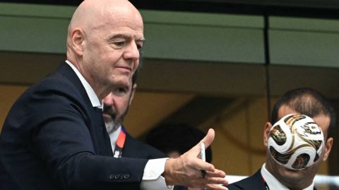 FIFA President Gianni Infantino (L) throws a replica match ball into the crowd at the end of the 2026 World Cup football tournament semi-final match between France and Spain at the Dallas Stadium in Arlington on July 14, 2026.