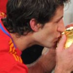 Spain's defender Joan Capdevila kisses the trophy during the award ceremony following their 2010 FIFA football World Cup match against the Netherlands on July 11, 2010 at Soccer City stadium in Soweto, suburban Johannesburg. Spain won the match 1-0. NO PUSH TO MOBILE / MOBILE USE SOLELY WITHIN EDITORIAL ARTICLE - AFP PHOTO / ROBERTO SCHMIDT