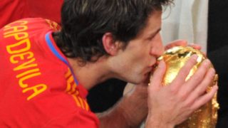 Spain's defender Joan Capdevila kisses the trophy during the award ceremony following their 2010 FIFA football World Cup match against the Netherlands on July 11, 2010 at Soccer City stadium in Soweto, suburban Johannesburg. Spain won the match 1-0. NO PUSH TO MOBILE / MOBILE USE SOLELY WITHIN EDITORIAL ARTICLE - AFP PHOTO / ROBERTO SCHMIDT