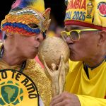 Colombian fans kiss a World Cup replica ahead of the 2026 World Cup round of 32 football match between Colombia and Ghana at the Kansas City Stadium in Kansas City on July 3, 2026.