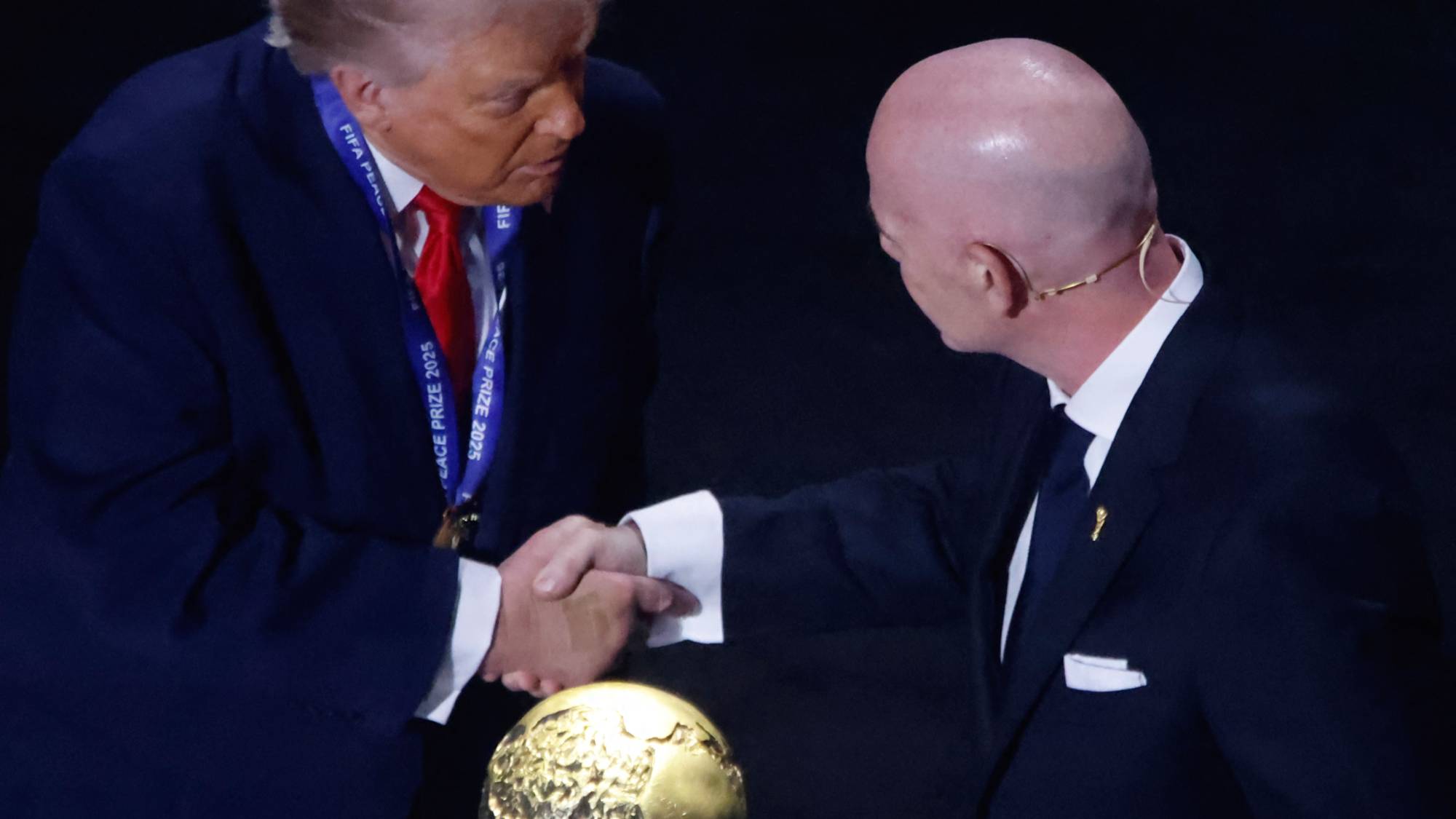 President Donald Trump receives the FIFA Peace Prize from FIFA President Gianni Infantino during the draw for the 2026 World Cup in the United States. (Photo by Deccio Serrano/NurPhoto)