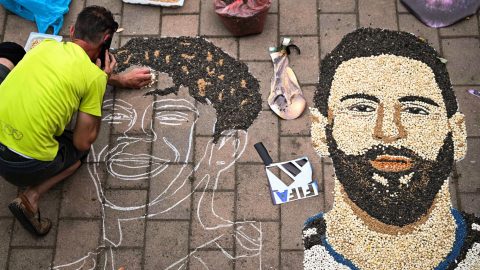 Kosovar artist Alkent Pozhegu works on a mosaic on the ground, made with grain and seeds, and depicting Argentina's forward #10 Lionel Messi (R) and Spain's forward #19 Lamine Yamal, in the town of Gjakova on July 16, 2026. Thousands of kilometres away from New York, where the Argentina and Spain football teams will compete for the World Cup title, in the western city of Gjakova, Alkent Pozhegu has made a mosaic depicting the two forward stars Lionel Messi and Lamine Yamal.