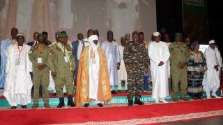 The head of Niger's military regime, General Abdourahamane Tiani (5h R), poses with members of the commission responsible for conducting the national conference in Niamey on February 15, 2025. The head of Niger's military regime, General Abdourahamane Tiani, launched five days of "national conferences" in Niamey on February 15, 2025, which are supposed to set the duration of the transition, which has been underway since a coup d'état in July 2023. (Photo by AFP)