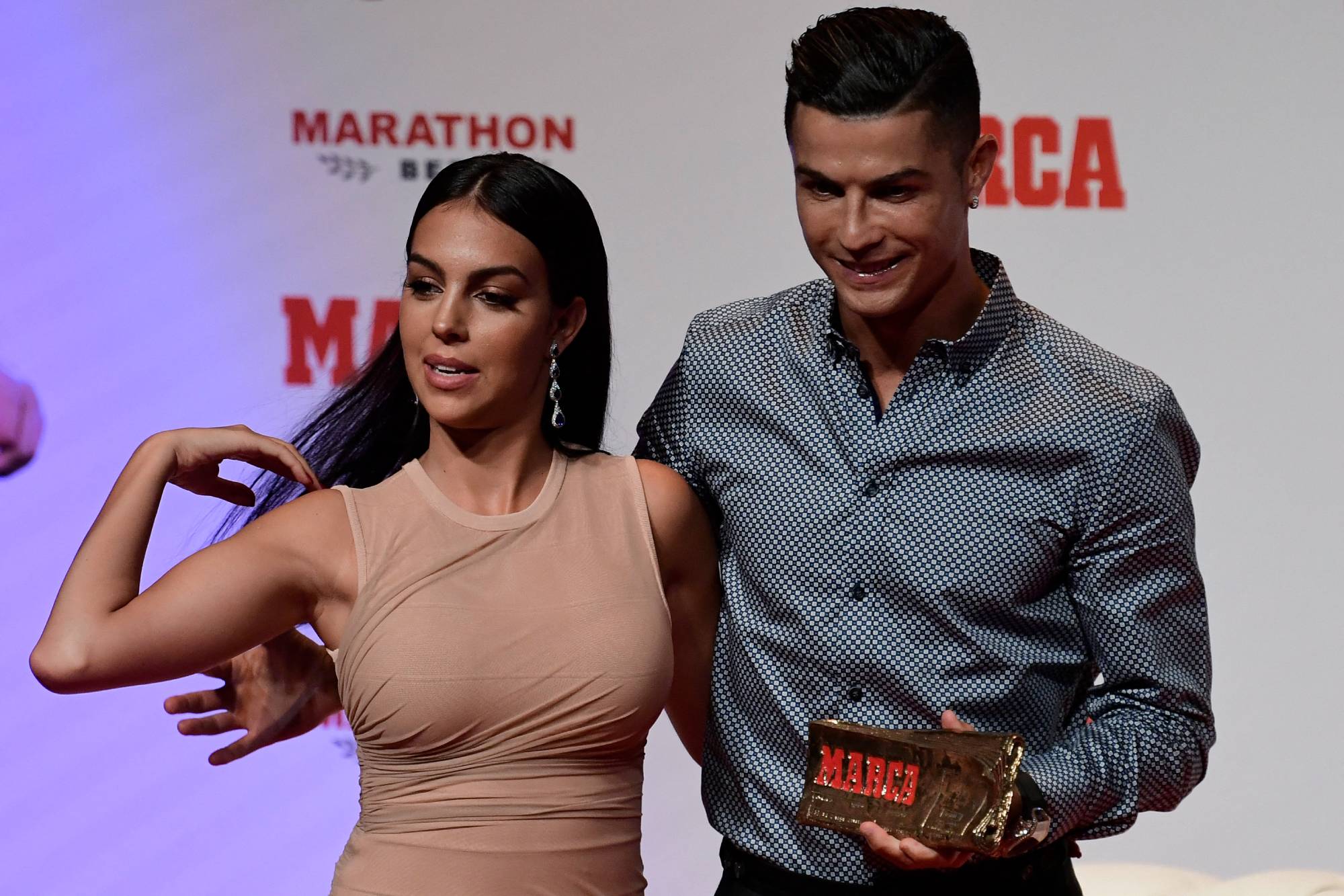 Portugal and Juventus forward Cristiano Ronaldo poses with his partner and Spanish model Georgina Rodriguez (L) after receiving the MARCA Leyenda (MARCA Legend) award in Madrid on July 29, 2019. The award is attributed to sport professionals by the Spanish sports newspaper MARCA.
