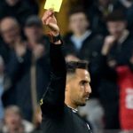 French referee Abdelatif Kherradji (R) delivers a yellow card to Nantes' French Goalkeeper #16 Anthony Lopes during the French L1 football match between Stade Rennais FC and FC Nantes at Roazhon Park stadium in Rennes, western France on April 18, 2025.