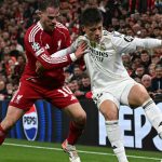 Real Madrid's Turkish midfielder #15 Arda Guler (R) vies with Liverpool's Argentinian midfielder #10 Alexis Mac Allister (L) during the UEFA Champions League, league phase football match between Liverpool and Real Madrid at Anfield in Liverpool, north west England on November 4, 2025.