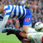 Queens Park Rangers Hungarian midfielder Ákos Buzsáky (L) vies with Manchester United's Brazilian defender Rafael Da Silva during the English Premier League football match between Manchester United and Queens Park Rangers at Old Trafford in Manchester, north-west England on April 8, 2012. AFP PHOTO/ANDREW YATES RESTRICTED TO EDITORIAL USE. No use with unauthorized audio, video, data, fixture lists, club/league logos or “live” services. Online in-match use limited to 45 images, no video emulation. No use in betting, games or single club/league/player publications.