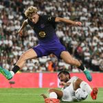 Barcelona's Spanish midfielder #07 Fermin Lopez (up) fights for the ball with Elche's Spanish defender #23 Victor Chust during the Spanish league football match between Elche CF and FC Barcelona at Martinez Valero Stadium in Elche on August 23, 2026.