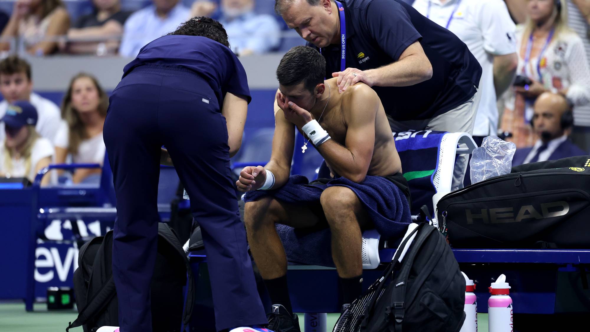 NEW YORK NEW YORK - AUGUST 30: Novak Djokovic of Serbia receives treatment from Clay Sniteman against Mariano Navone of Argentina during their Men's Singles First Round match on Day One of the 2026 US Open at USTA Billie Jean King National Tennis Center on August 30, 2026 in the Flushing neighborhood of the Queens borough of New York City. (Photo by Julian Finney/Getty Images)