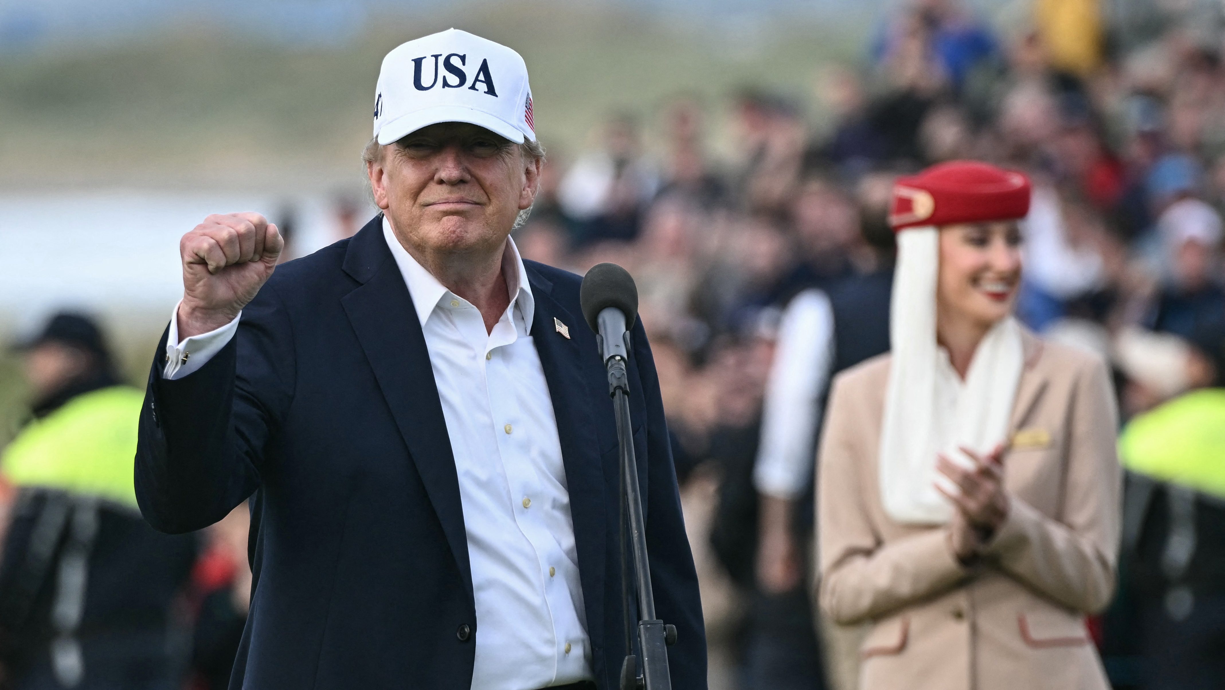 US President Donald Trump (L) gestures as he waits to present the winner's trophy to Ireland's Shane Lowry (not pictured) following his victory on the final day of the Irish Open golf tournament at the Trump International Golf Links & Hotel, a resort and golf course owned by the president, in Doonbeg, western Ireland on September 13, 2026. (Photo by Brendan SMIALOWSKI / AFP)