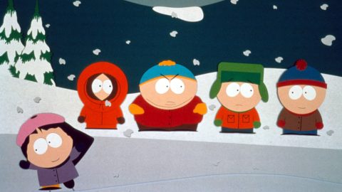 Four animated kids in colorful winter clothes stand in the snowy outdoors, with a girl in a purple coat leaning into the frame.