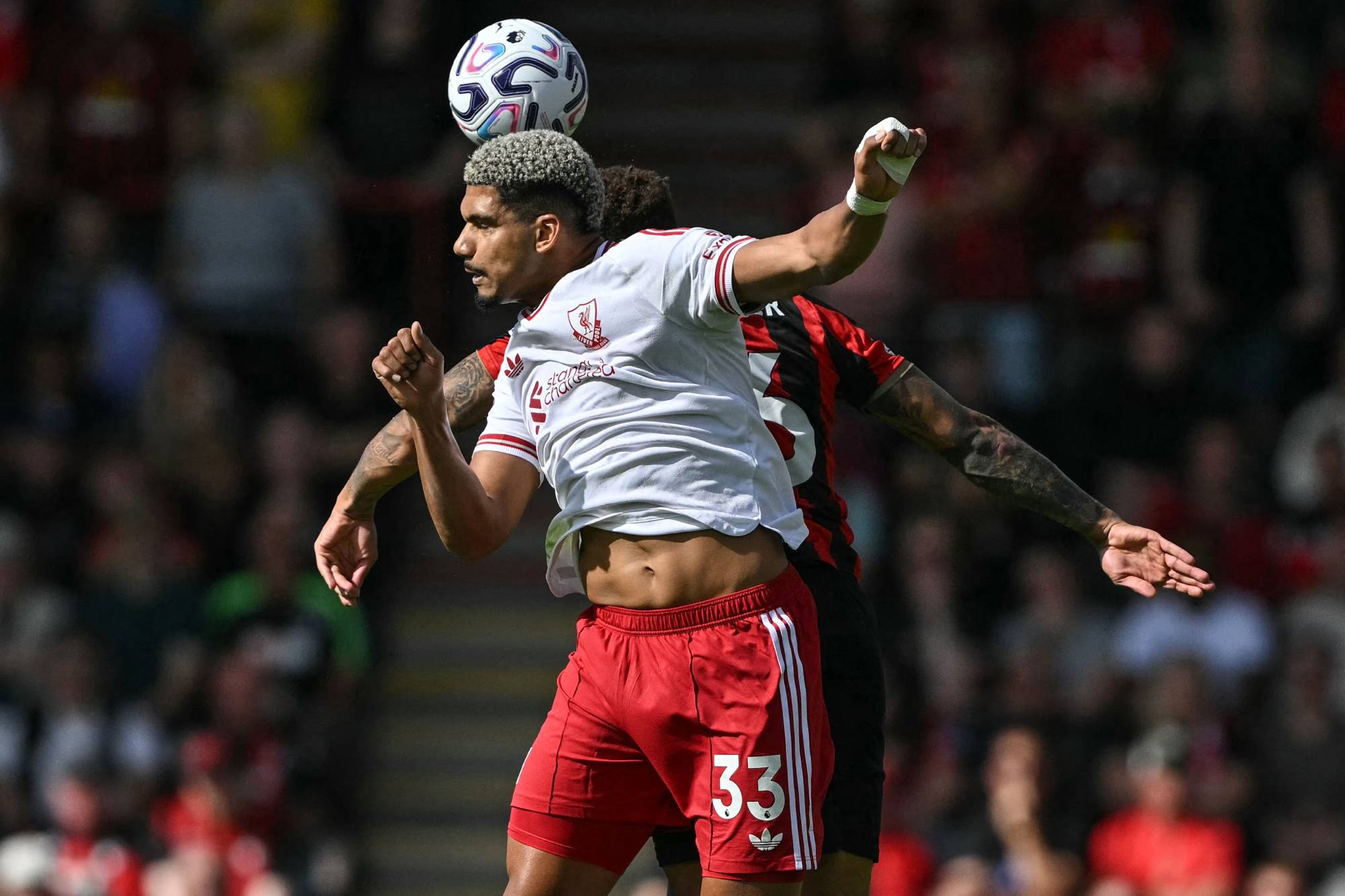 Liverpool's Uruguayan defender #33 Ronald Araujo (front) jumps for a header with Bournemouth's English midfielder #16 Marcus Tavernier (behind) during the English Premier League football match between Bournemouth and Liverpool at the Vitality Stadium in Bournemouth, southern England on September 20, 2026.