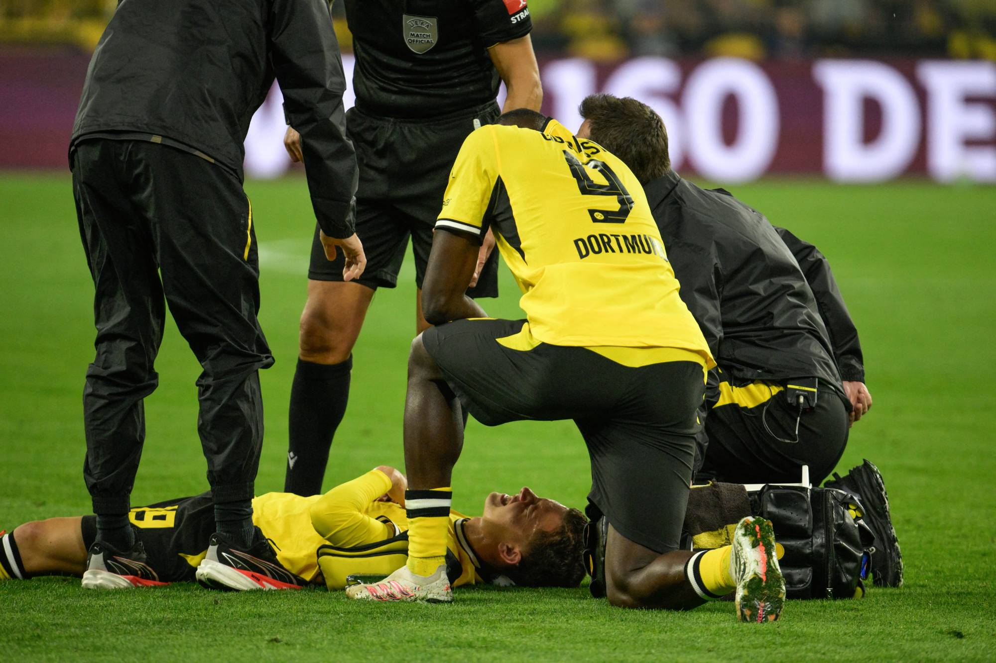 Borussia Dortmund's Greek midfielder #19 Konstantinos Karetsas lays on the pitch after injury during the UEFA Champions League - League phase, Matchday 1 - football match between BVB Borussia Dortmund and Villarreal CF in Dortmund, western Germany, on September 8, 2026.
