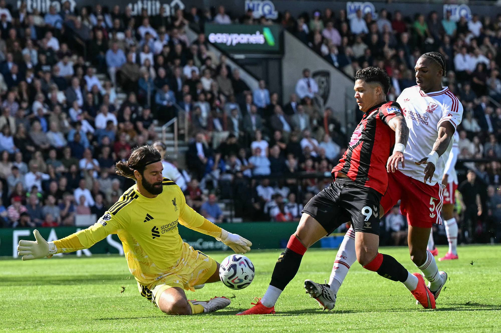Bournemouth's Brazilian striker #09 Evanilson (C) tries to shoot past Liverpool's Brazilian goalkeeper #01 Alisson Becker (L) during the English Premier League football match between Bournemouth and Liverpool at the Vitality Stadium in Bournemouth, southern England on September 20, 2026.