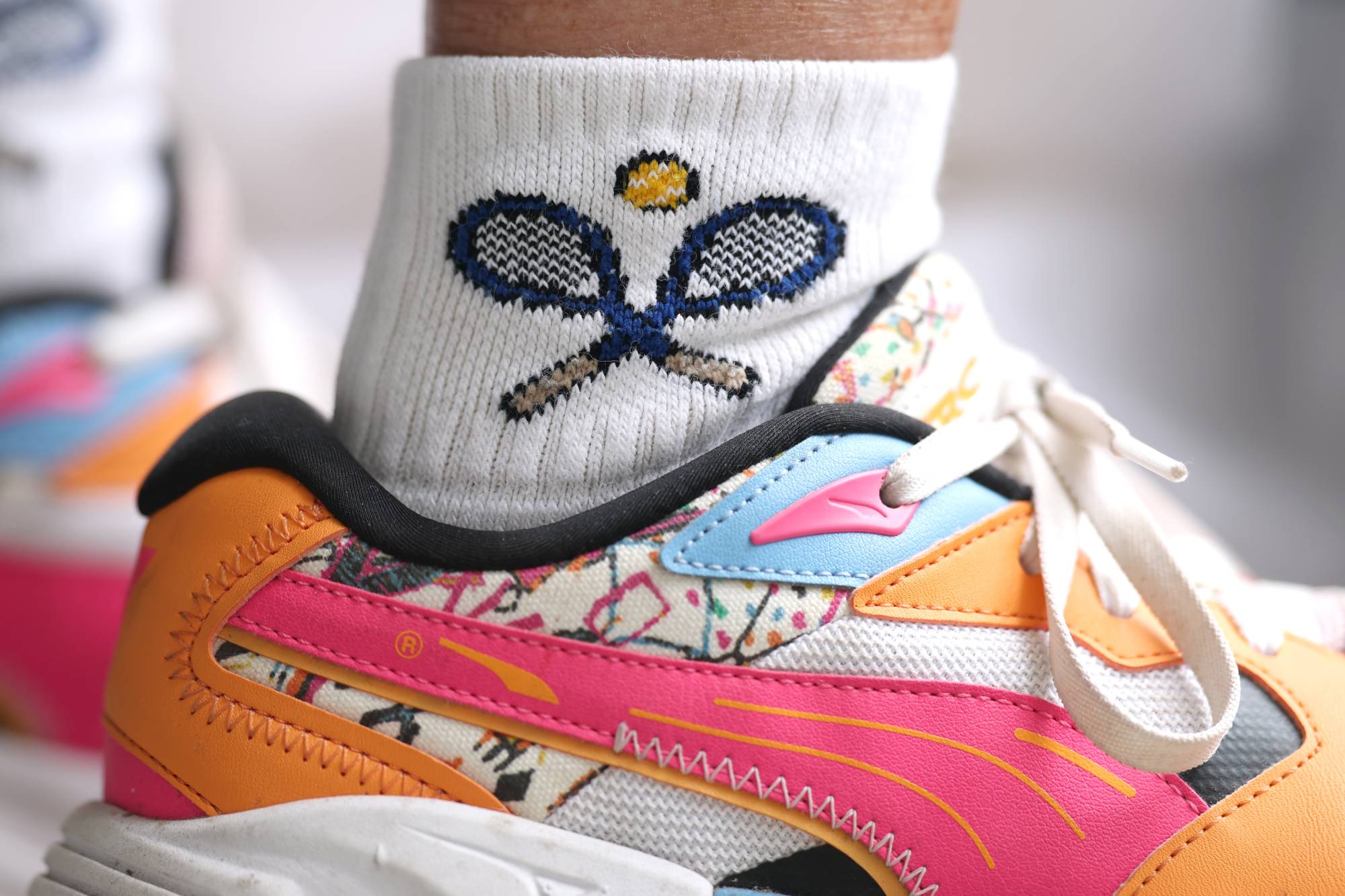 NEW YORK, NEW YORK - SEPTEMBER 02: Tennis rackets adorn the socks of a spectator during Day Four of the 2026 US Open at USTA Billie Jean King National Tennis Center on September 02, 2026 in the Flushing neighborhood of the Queens borough of New York City. (Photo by Julian Finney/Getty Images)