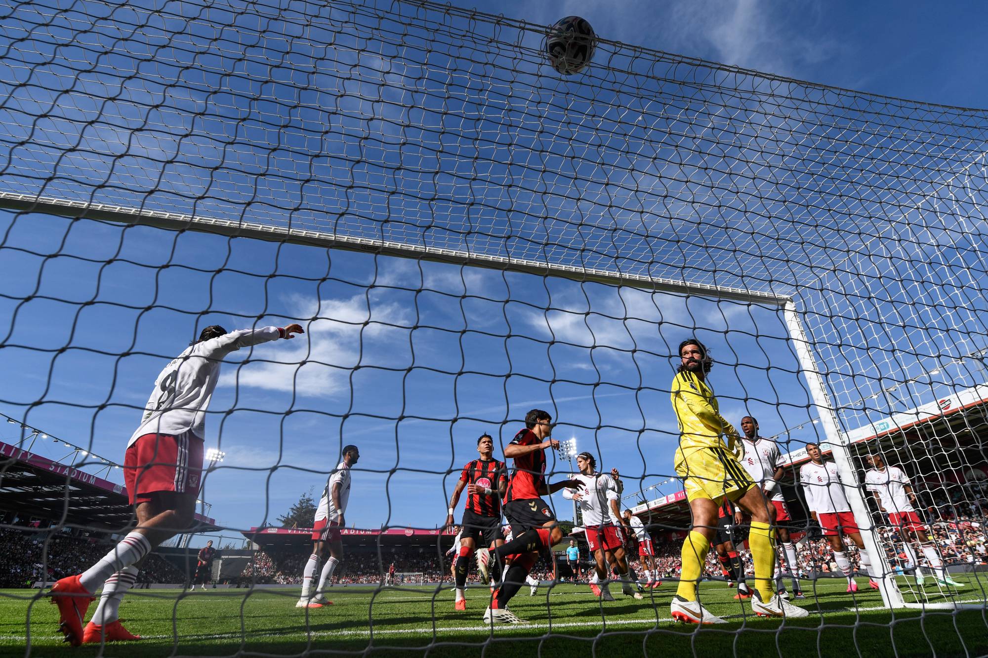 Liverpool's Brazilian goalkeeper #01 Alisson Becker (R) looks up as the ball goes over the crossbar during the English Premier League football match between Bournemouth and Liverpool at the Vitality Stadium in Bournemouth, southern England on September 20, 2026.