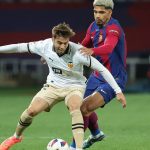 Valencia's Spanish forward #22 Alberto Mari fights for the ball with Barcelona's Uruguayan defender #04 Ronald Araujo during the Spanish league football match between FC Barcelona and Valencia CF at the Estadi Olimpic Lluis Companys in Barcelona on April 29, 2024.