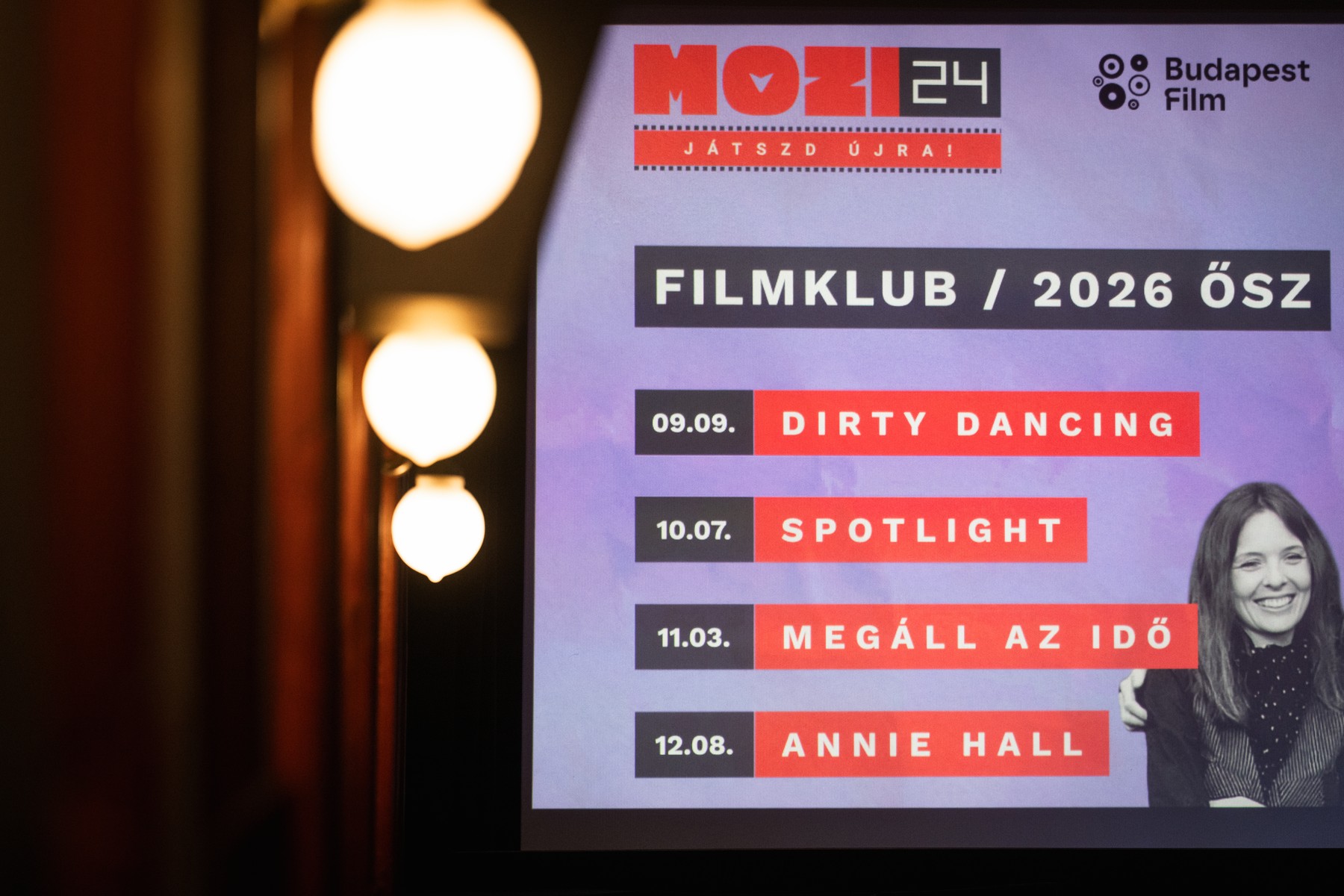 Poster advertising film club events with MOZI24 and Budapest Film logos; lists titles like Dirty Dancing, Spotlight, Megáll az idő, Annie Hall on a purple background.