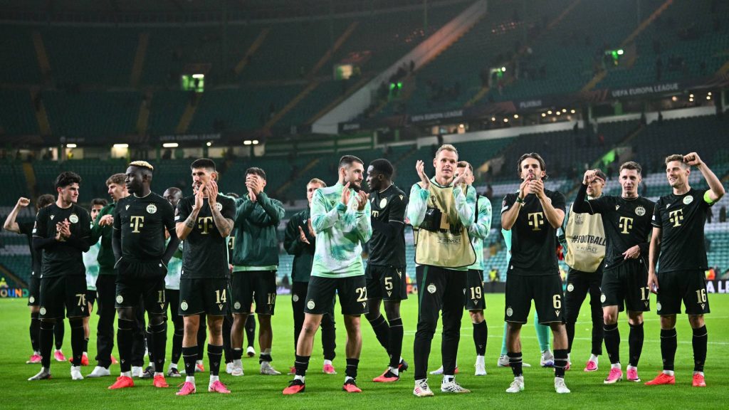 Ferencvaros' Norwegian midfielder #16 Kristoffer Zachariassen (R) and teammates applaud the fans following the UEFA Europa League, League phase football match between Celtic and Ferencvaros at Celtic Park in Glasgow on September 17, 2026.