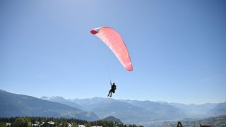 CRANS-MONTANA, SWITZERLAND - SEPTEMBER 06: A paraglider on day four of the Omega European Masters at Crans-sur-Sierre Golf Club on September 06, 2026 in Crans-Montana, Switzerland. (Photo by Stuart Franklin/Getty Images)