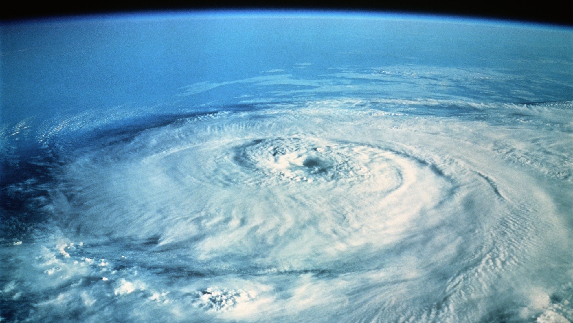 Satellite image of a powerful cyclone over the ocean with a visible eye on the center of the storm.