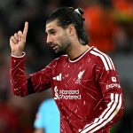 Liverpool's Hungarian midfielder #08 Dominik Szoboszlai celebrates after scoring the equalising goal during the UEFA Champions League football match between Liverpool and Atletico Madrid at Anfield in Liverpool, north west England on September 9, 2026.