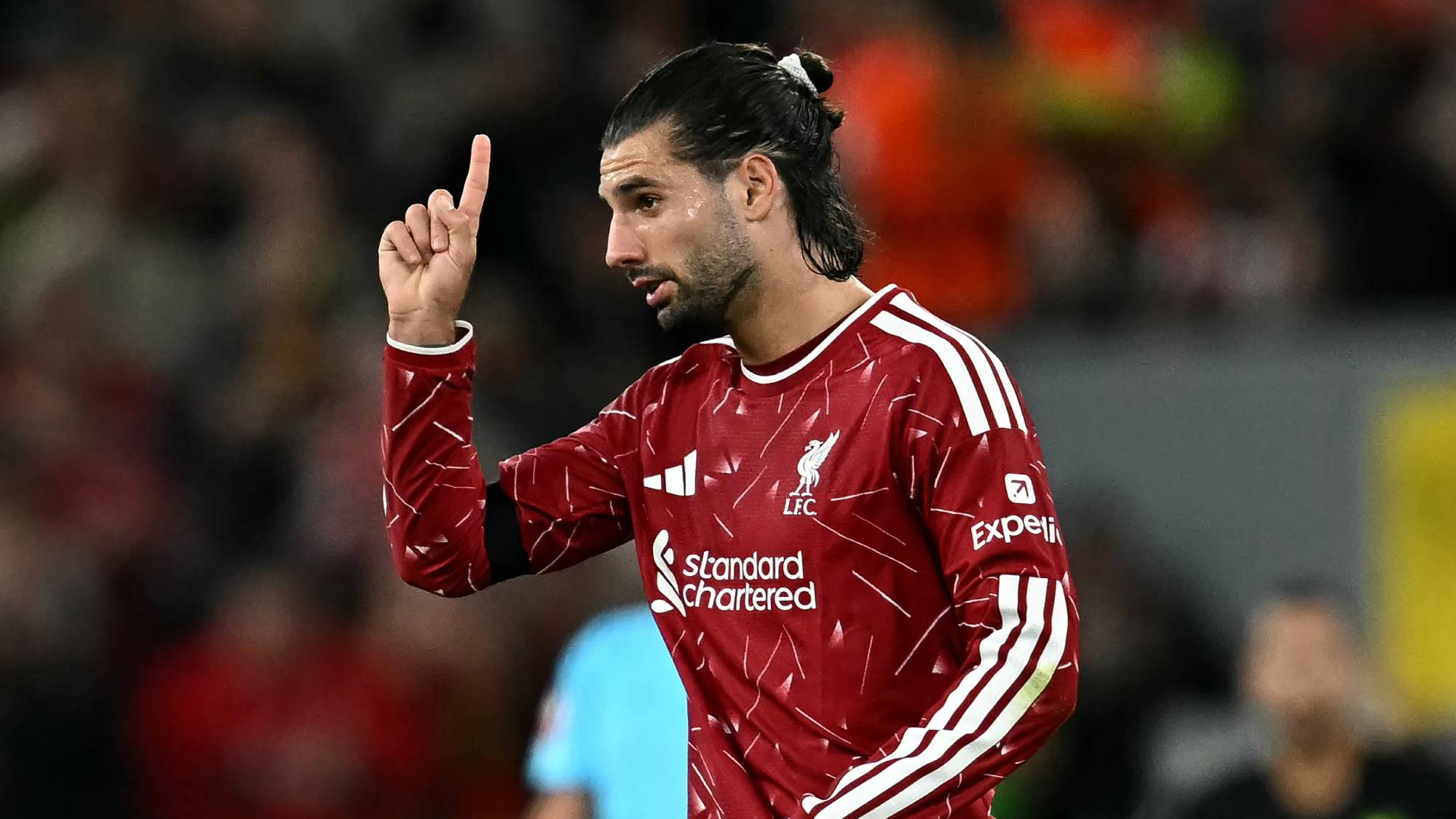 Liverpool's Hungarian midfielder #08 Dominik Szoboszlai celebrates after scoring the equalising goal during the UEFA Champions League football match between Liverpool and Atletico Madrid at Anfield in Liverpool, north west England on September 9, 2026.