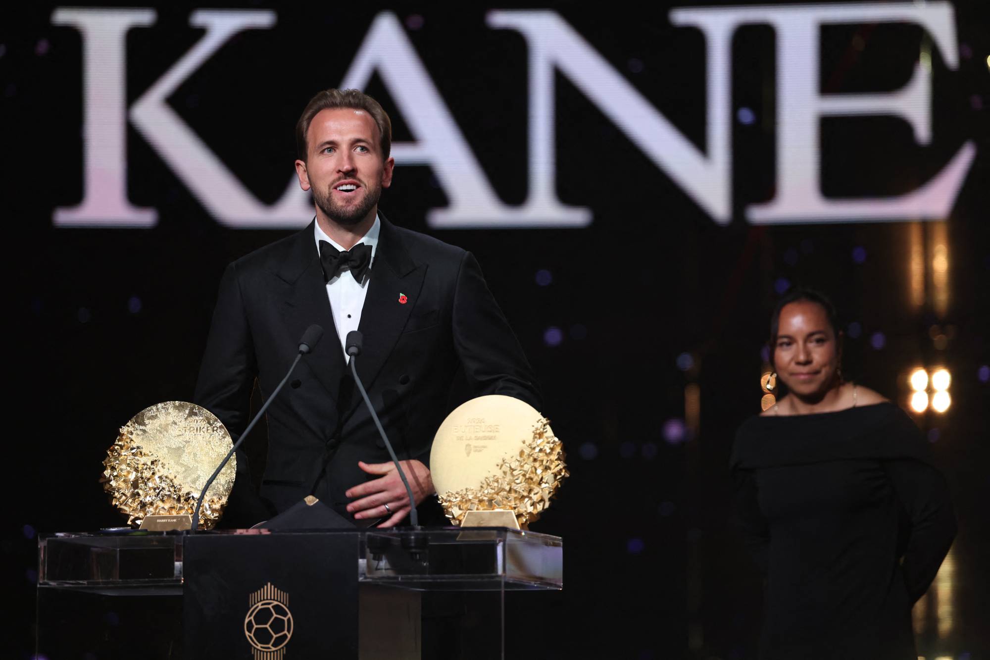 England and Bayern Munich forward Harry Kane speaks on stage after receiving the Gerd Muller Trophy for the Best Striker during the 2026 Ballon d'Or France Football award ceremony at the Palladium Theatre in London on October 26, 2026.