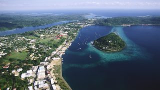 An aerial photograph of Port Vila, the capital of Vanuatu, also shows Iririki Island in Port Vila Bay. | Location: Port Vila, Efate Island, Vanuatu.