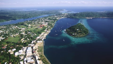 An aerial photograph of Port Vila, the capital of Vanuatu, also shows Iririki Island in Port Vila Bay. | Location: Port Vila, Efate Island, Vanuatu.