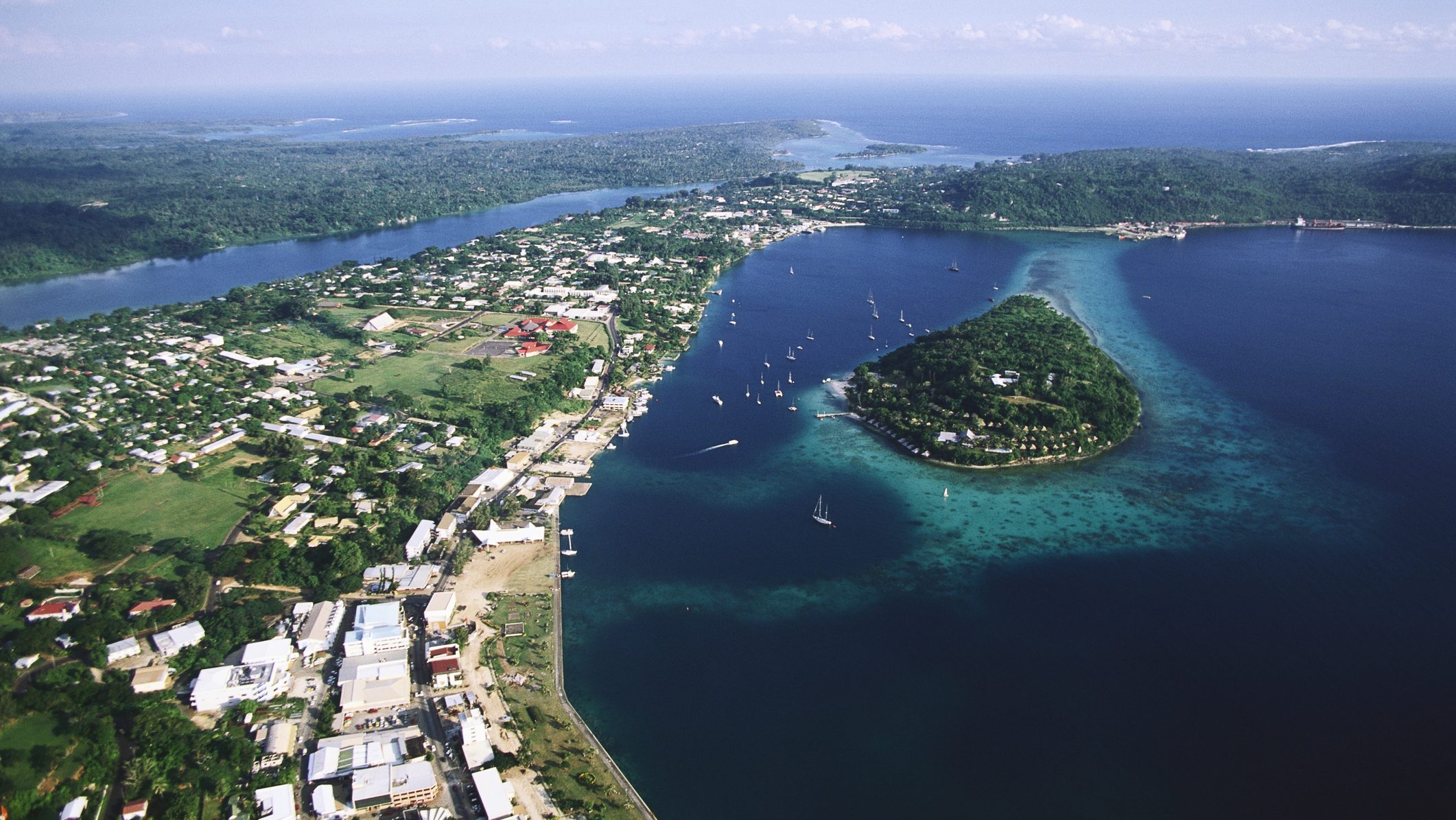 An aerial photograph of Port Vila, the capital of Vanuatu, also shows Iririki Island in Port Vila Bay. | Location: Port Vila, Efate Island, Vanuatu.