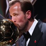 England and Bayern Munich forward Harry Kane kisses the trophy on stage after receiving the Ballon d'Or award for the best male footballer during the 2026 Ballon d'Or France Football award ceremony at the Palladium Theatre in London on October 26, 2026.