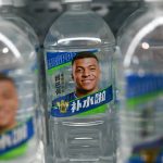 Bottles of Dongpeng Beverage Group's "Bushuila" electrolyte drink featuring French football star Kylian Mbappe on the packaging are displayed at a convenience store in Beijing on October 27, 2026. Kylian Mbappe was dropped October 27 by two major brands in China after a video circulated online in which the French football star apparently joked about former leader Mao Zedong.