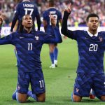 France's midfielder #11 Michael Olise (L) celebrates with France's forward #20 Desire Doue after scoring his team's fourth goal during the UEFA Nations League Group A1 football match between France and Belgium at the Stade de France in Saint-Denis, north of Paris, on October 5, 2026.