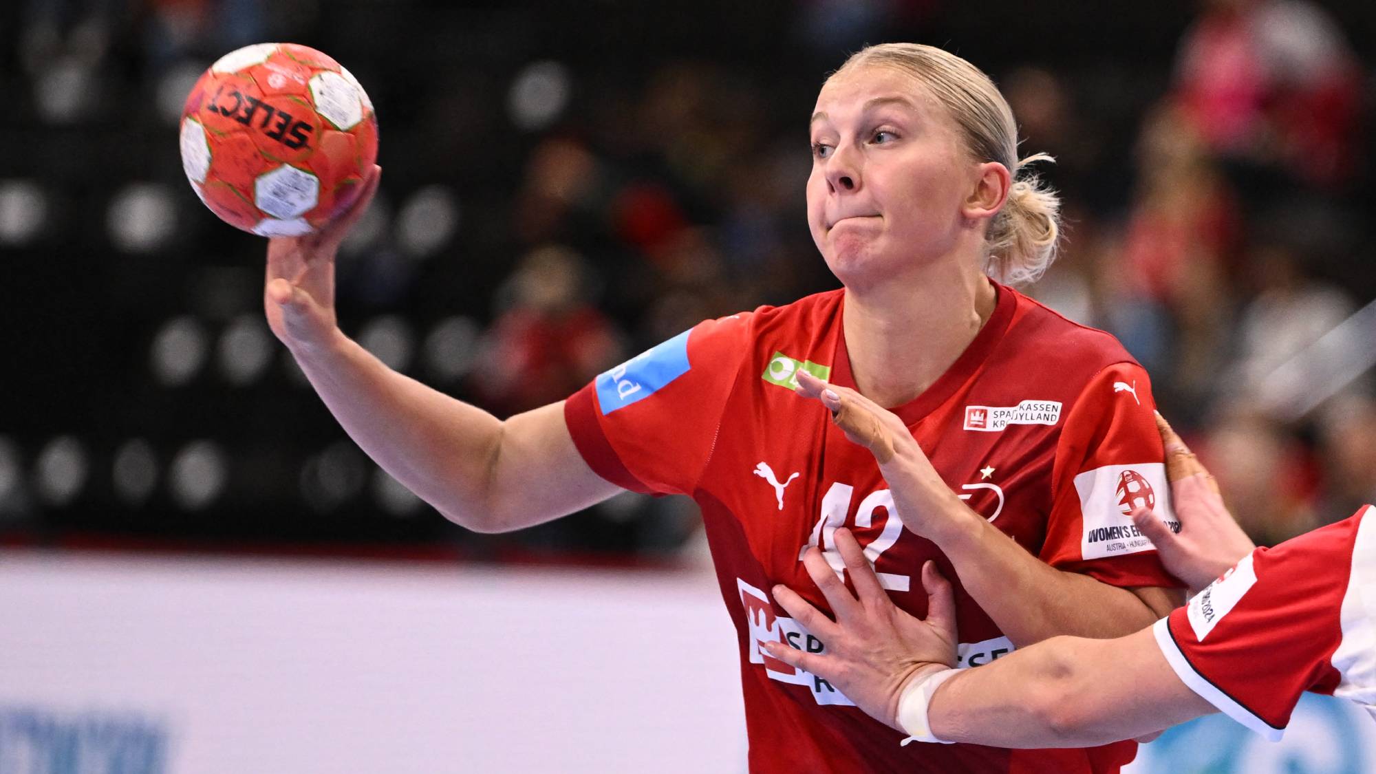 Denmark's left back #42 Michala Elsberg Moller (L) passes the ball in front of Croatia's left back #04 Tina Barisic during the women's EHF 2024 European championship handball game between Denmark and Croatia at the St Jakobshalle in Basel on November 29, 2024.