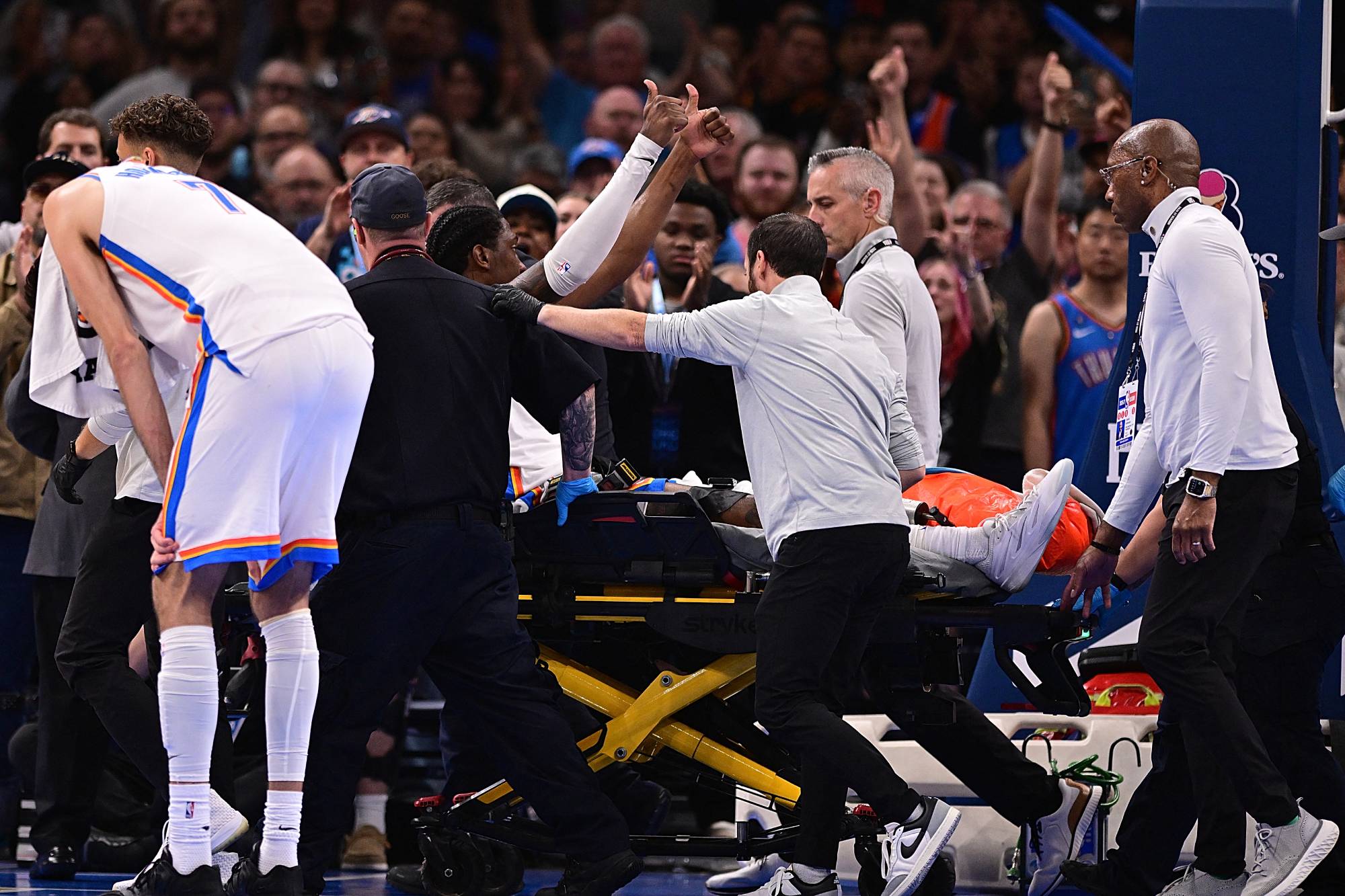 OKLAHOMA CITY, OKLAHOMA - OCTOBER 25: Jalen Williams #8 of the Oklahoma City Thunder gives a thumbs up to the crowd while being carted off after an injury during the second half against the LA Clippers at Paycom Center on October 25, 2026 in Oklahoma City, Oklahoma. NOTE TO USER: User expressly acknowledges and agrees that, by downloading and or using this photograph, User is consenting to the terms and conditions of the Getty Images License Agreement. Joshua Gateley/Getty Images/AFP 