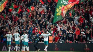 Portugal's defender #20 Joao Cancelo (R) celebrates scoring the opening goal with his teammates during the UEFA Nations League Group A4 match between Denmark and Portugal at Parken stadium in Copenhagen on October 1, 2026.