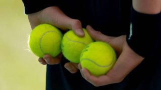 A photo shows a ball boy with tennis balls. Grigor Dimitrov of Bulgaria plays against Matteo Berrettini of Italy during the men's singles third round match on day six of the 2026 Wimbledon Championships at All England Lawn Tennis and Croquet Club in London, on July 4, 2026. ( The Yomiuri Shimbun )
