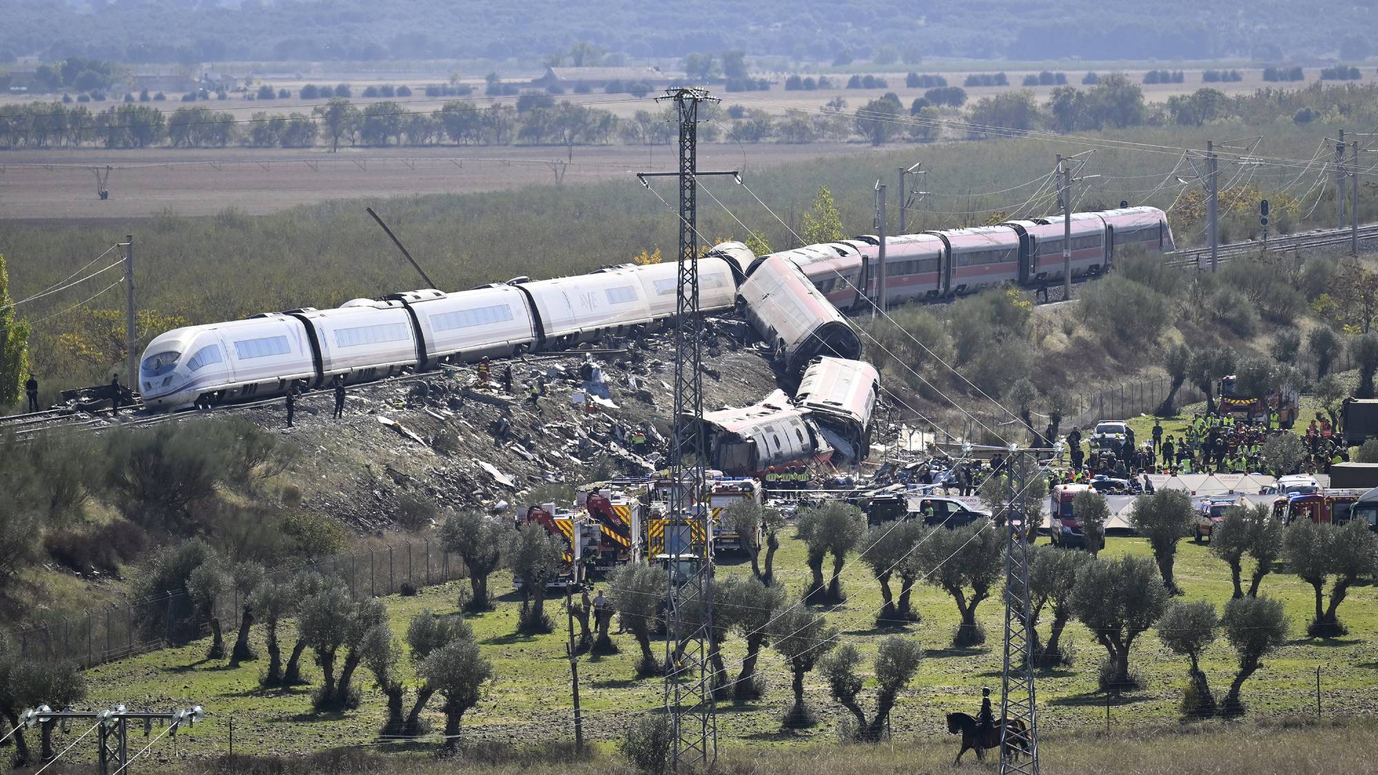 TOLEDO, SPAIN - OCTOBER 28: Emergency teams work at the scene of a collision involving two high-speed trains near Urda station in Toledo province, Spain, on October 28, 2026. The death toll has risen to 64, according to Spanish media reports. Preliminary information suggests that a Renfe AVE train struck the rear of a stationary Iryo train, causing two carriages to derail and fall down an embankment. Emergency crews continue rescue and response operations as authorities investigate the cause of the collision. Burak Akbulut / Anadolu