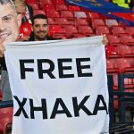 A fan of Switzerland's midfielder Granit Xhaka hlds up a banner in the crowd ahead of the UEFA Nations League, League B, Group 1 match football match between Scotland and Switzerland at Hampden Park in Glasgow, Scotland on September 29, 2026.