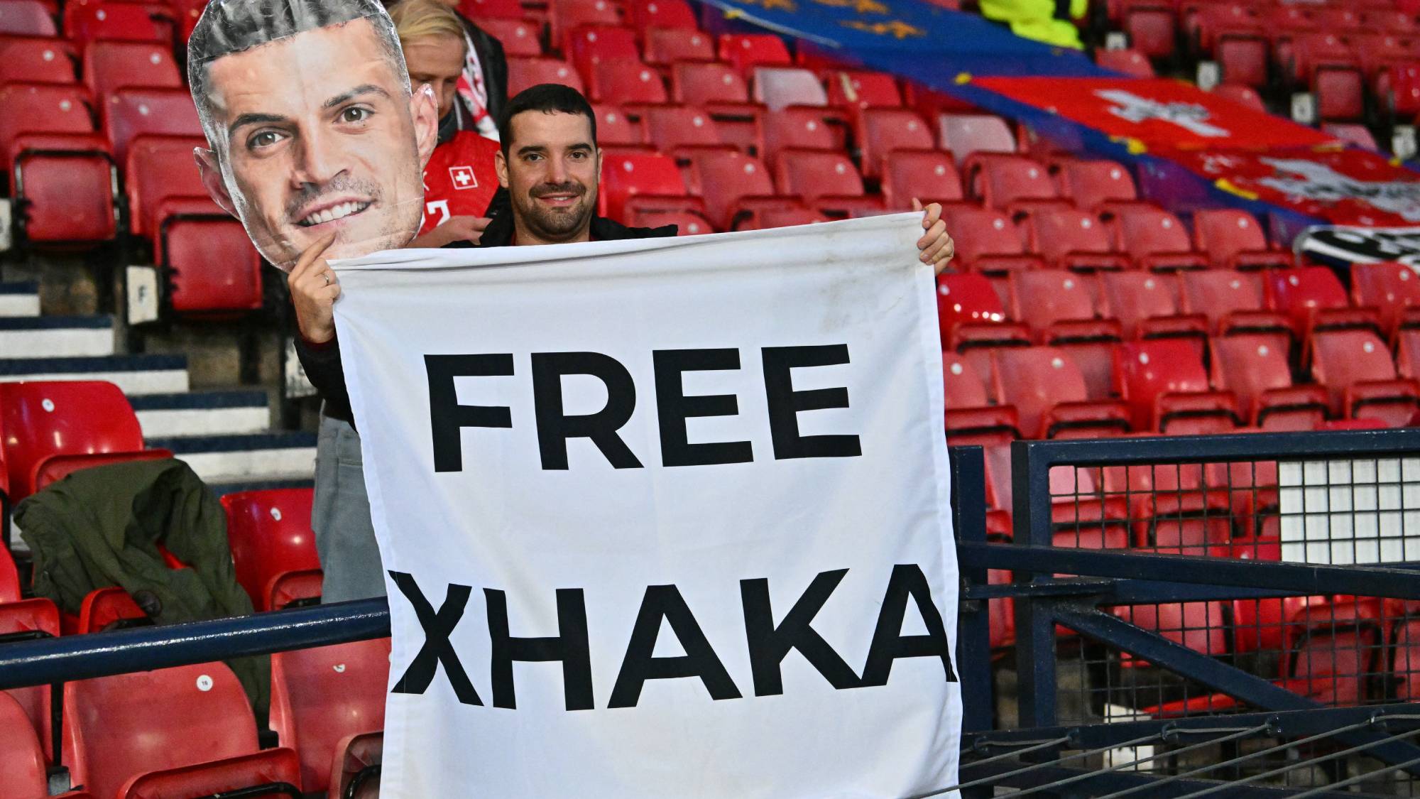 A fan of Switzerland's midfielder Granit Xhaka hlds up a banner in the crowd ahead of the UEFA Nations League, League B, Group 1 match football match between Scotland and Switzerland at Hampden Park in Glasgow, Scotland on September 29, 2026.