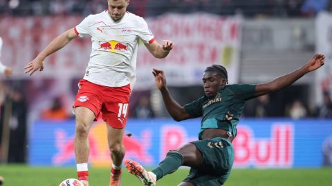 Leipzig's Austrian midfielder #14 Christoph Baumgartner and Bremen's German defender #31 Karim Coulibaly vie for the ball during the German first division Bundesliga football match between RB Leipzig and Werder Bremen in Leipzig on November 23, 2025.