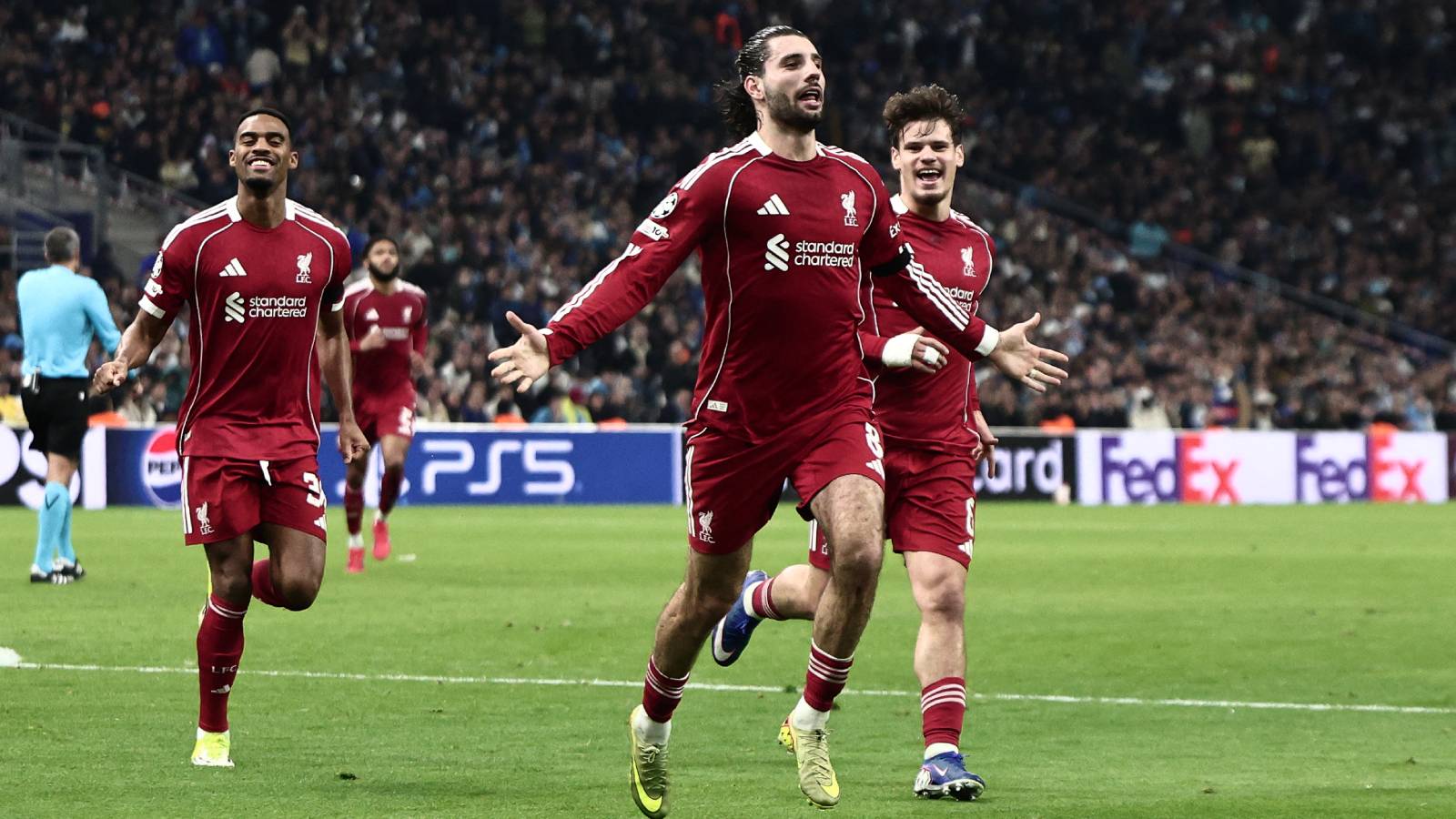 Liverpool's Hungarian midfielder #08 Dominik Szoboszlai (C) celebrates scoring his team's first goal during the UEFA Champions League, league phase day 7, football match between Olympique de Marseille (OM) and Liverpool FC at the Stade Velodrome in Marseille, southern France, on January 21, 2026.