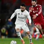 Qarabag's Cape Verdean midfielder #15 Leandro Andrade is put under pressure by Liverpool's Hungarian midfielder #08 Dominik Szoboszlai during the UEFA Champions League football match between Liverpool and Qarabag at Anfield in Liverpool, north west England on January 28, 2026.