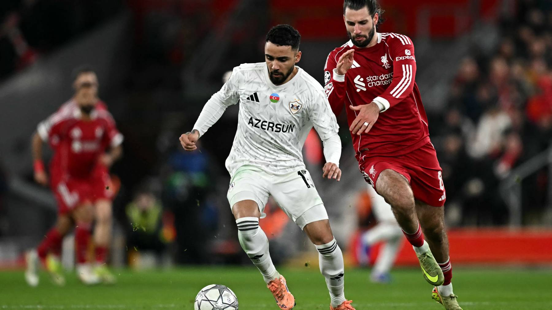 Qarabag's Cape Verdean midfielder #15 Leandro Andrade is put under pressure by Liverpool's Hungarian midfielder #08 Dominik Szoboszlai during the UEFA Champions League football match between Liverpool and Qarabag at Anfield in Liverpool, north west England on January 28, 2026.