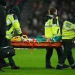 Liverpool's Japanese midfielder #03 Wataru Endo is carried off on a stretcher during the English Premier League football match between Sunderland and Liverpool at The Stadium of Light in Sunderland in north east England on February 11, 2026.