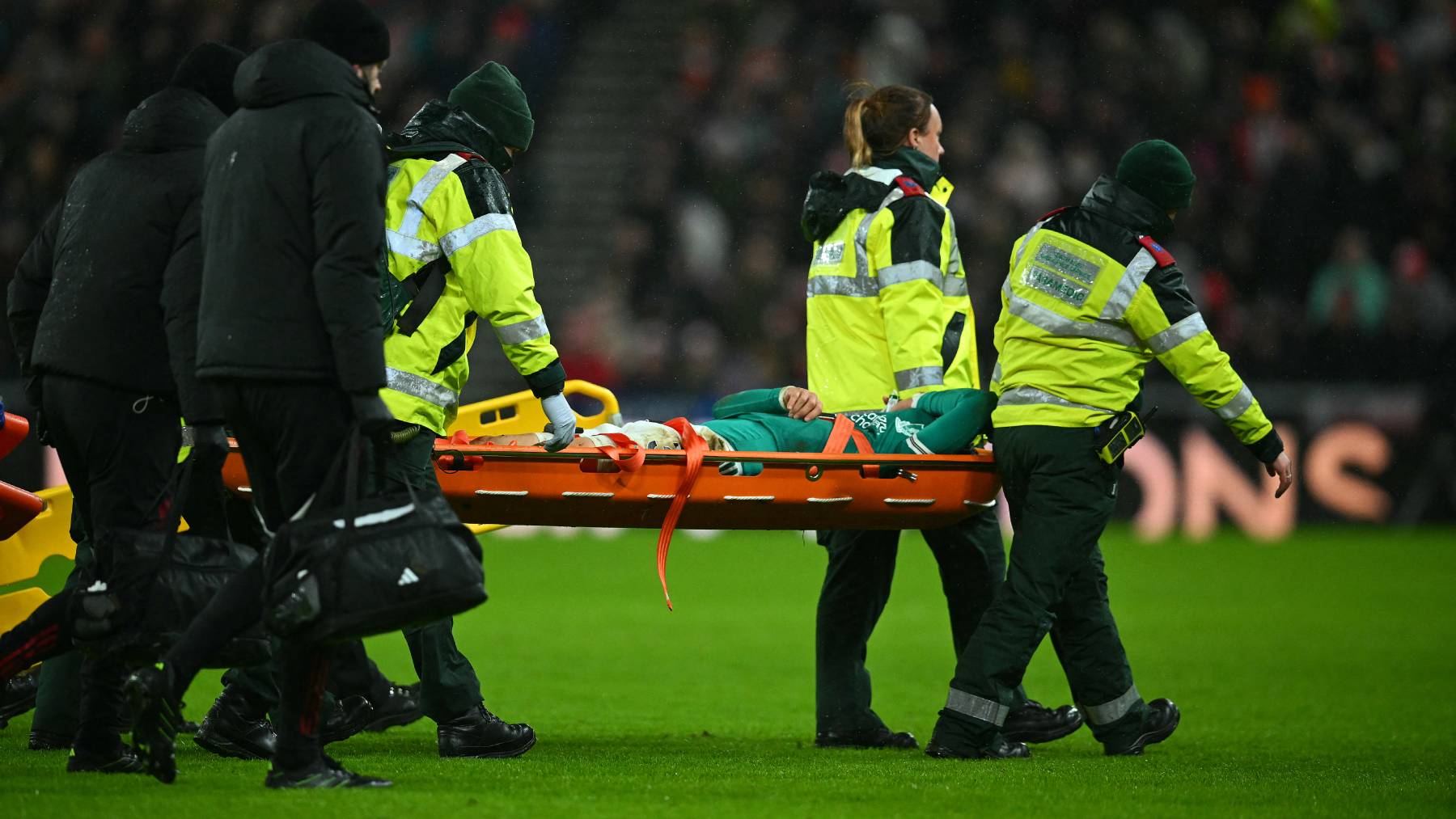 Liverpool's Japanese midfielder #03 Wataru Endo is carried off on a stretcher during the English Premier League football match between Sunderland and Liverpool at The Stadium of Light in Sunderland in north east England on February 11, 2026.