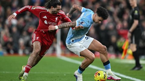 Manchester City's English midfielder #33 Nico O'Reilly (R) is challenged by Liverpool's Hungarian midfielder #08 Dominik Szoboszlai (L) during the English Premier League football match between Liverpool and Manchester City at Anfield in Liverpool, north west England on February 8, 2026.