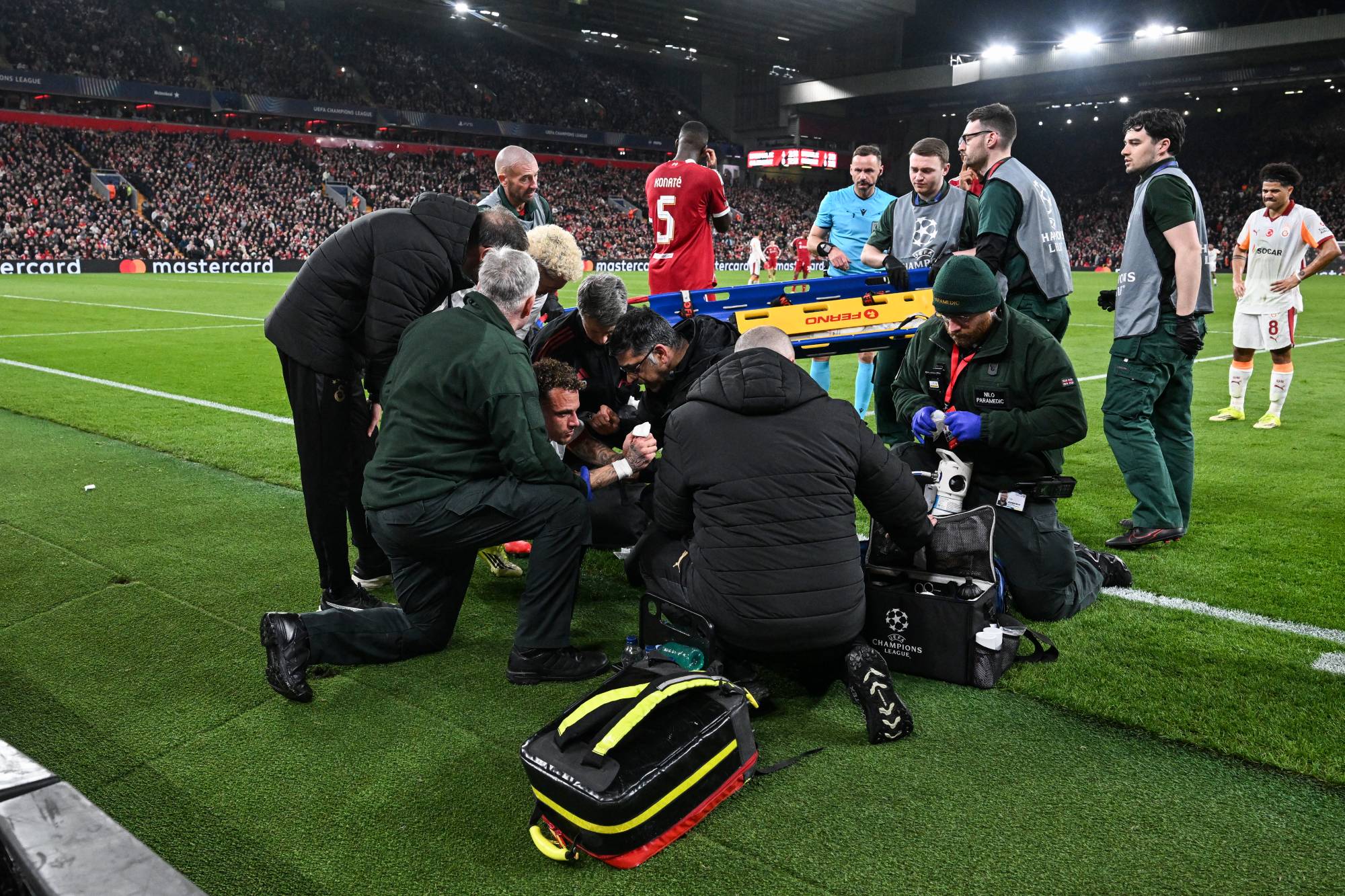 Galatasaray's Dutch forward #77 Noa Lang (C) receives medical attention after cutting his thumb during the UEFA Champions League, round of 16 second leg football match between Liverpool and Galatasaray at Anfield in Liverpool, north-west England on March 18, 2026.