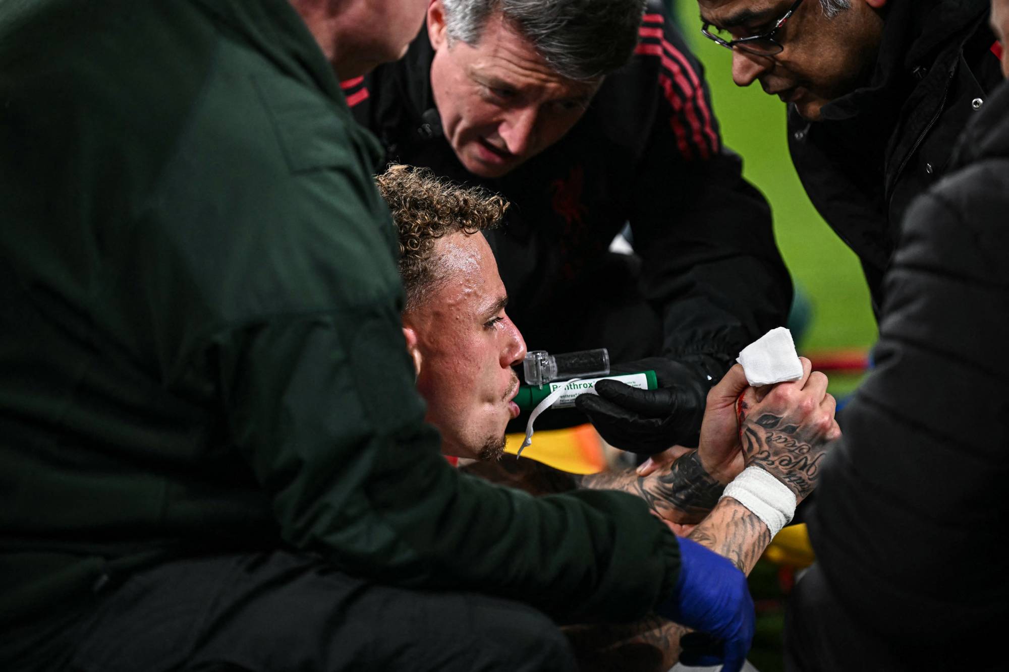 Galatasaray's Dutch forward #77 Noa Lang receives medical attention after cutting his thumb during the UEFA Champions League, round of 16 second leg football match between Liverpool and Galatasaray at Anfield in Liverpool, north-west England on March 18, 2026.